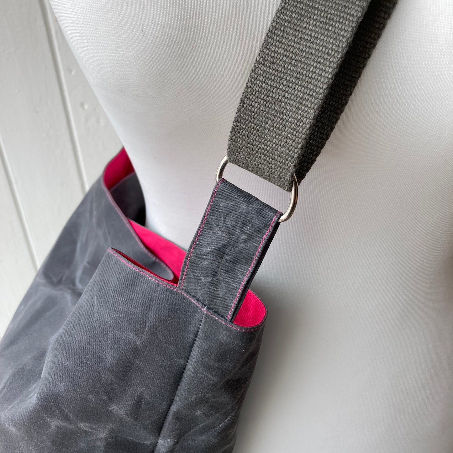 medium grey oilskin bucket bag with shocking pink lining
