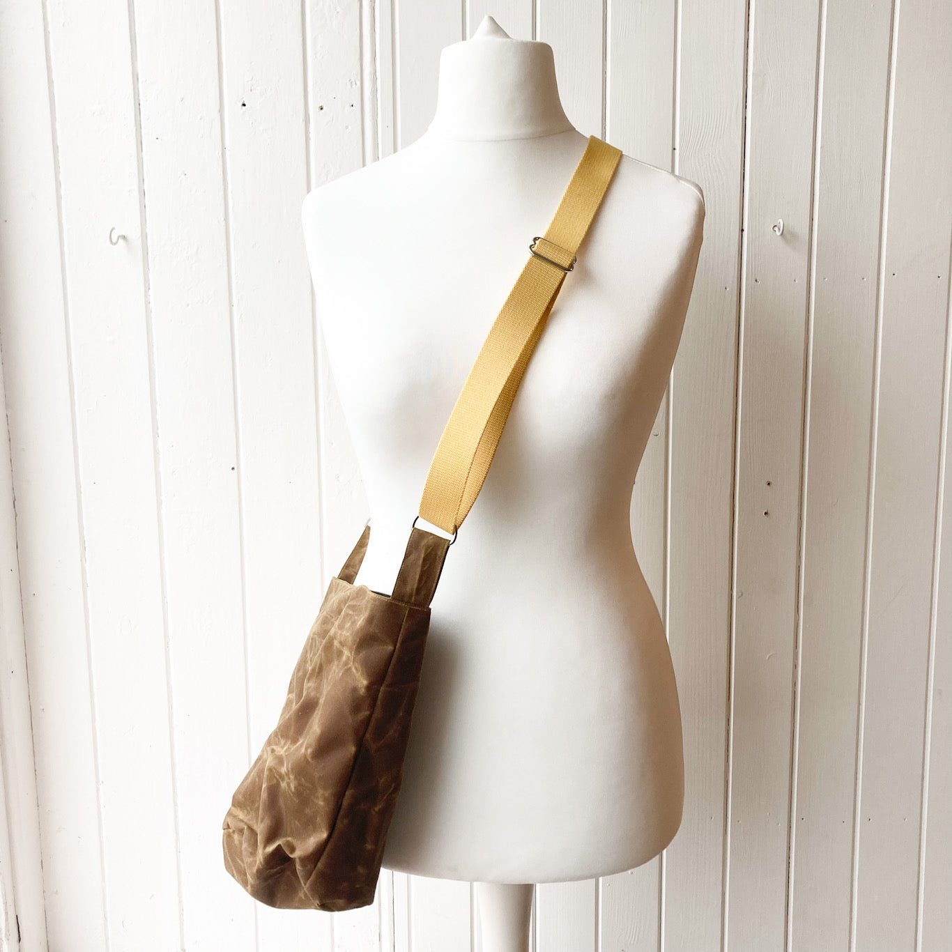 small tan oilskin bucket bag