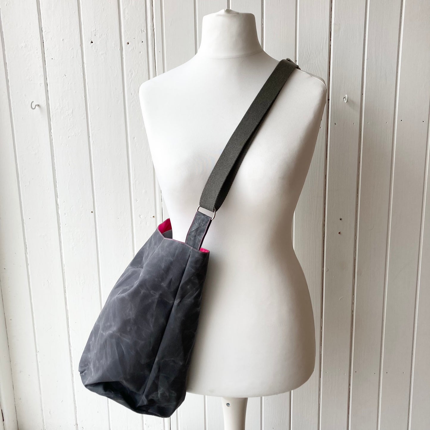 medium grey oilskin bucket bag with shocking pink lining