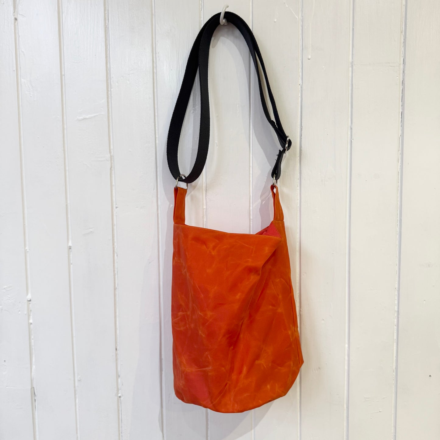 small orange oilskin bucket bag