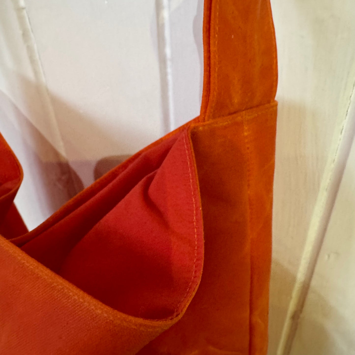 small orange oilskin bucket bag