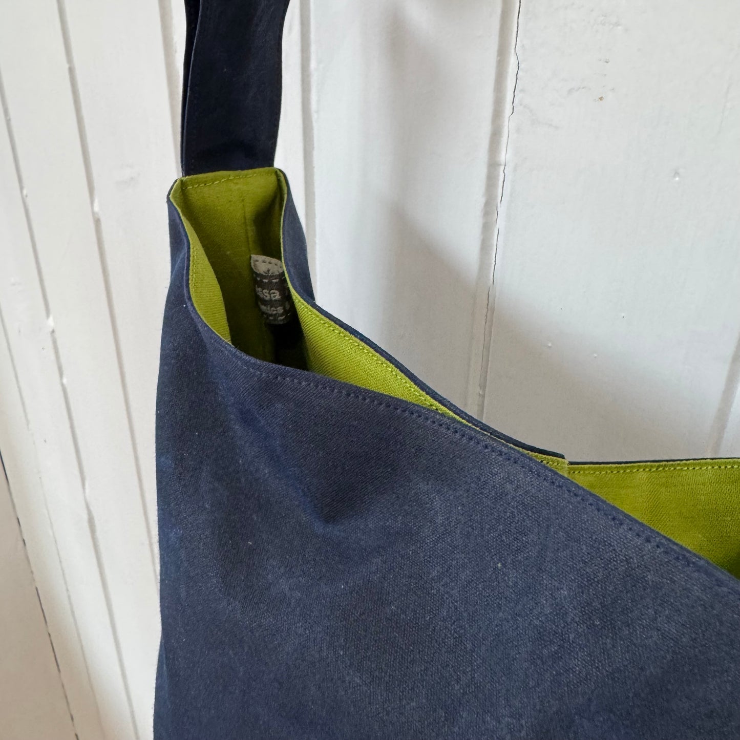 small dark blue oilskin bucket bag