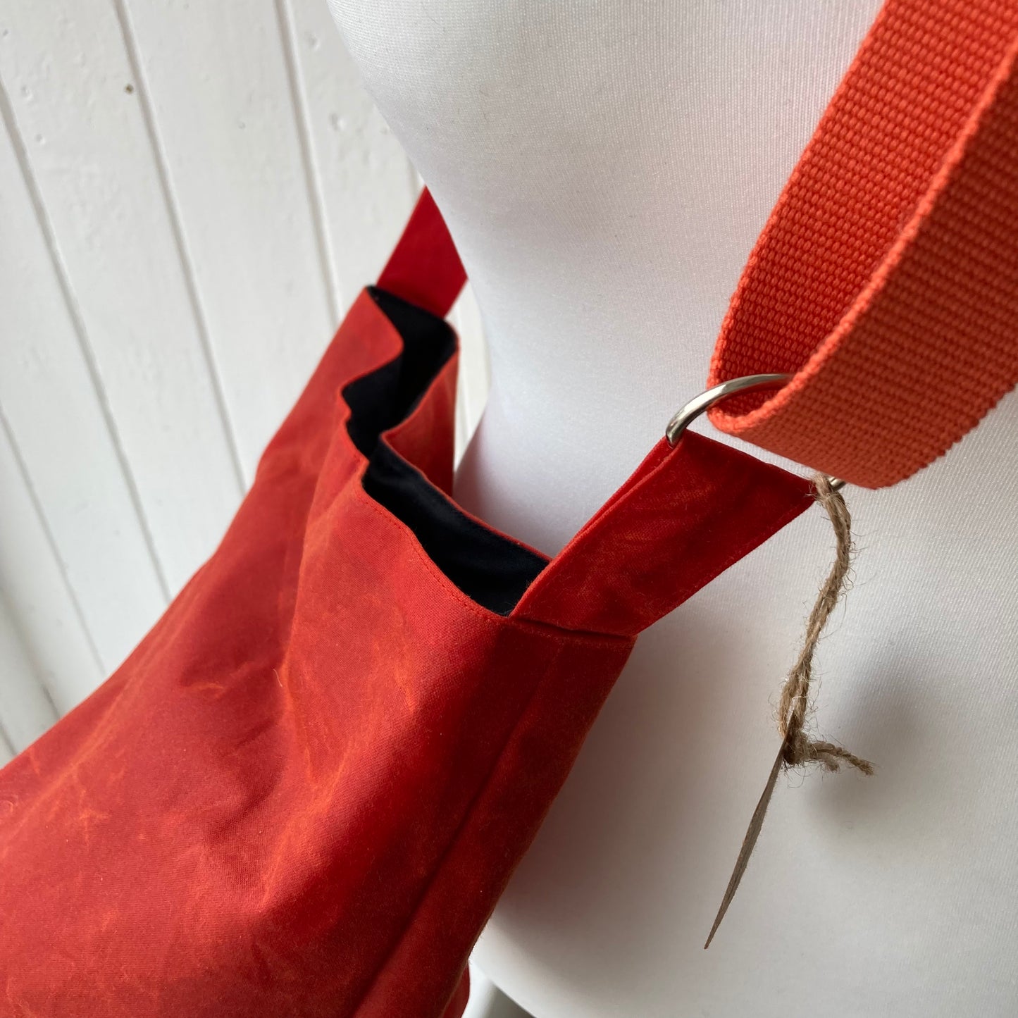 small dark orange oilskin bucket bag with pale pink lining