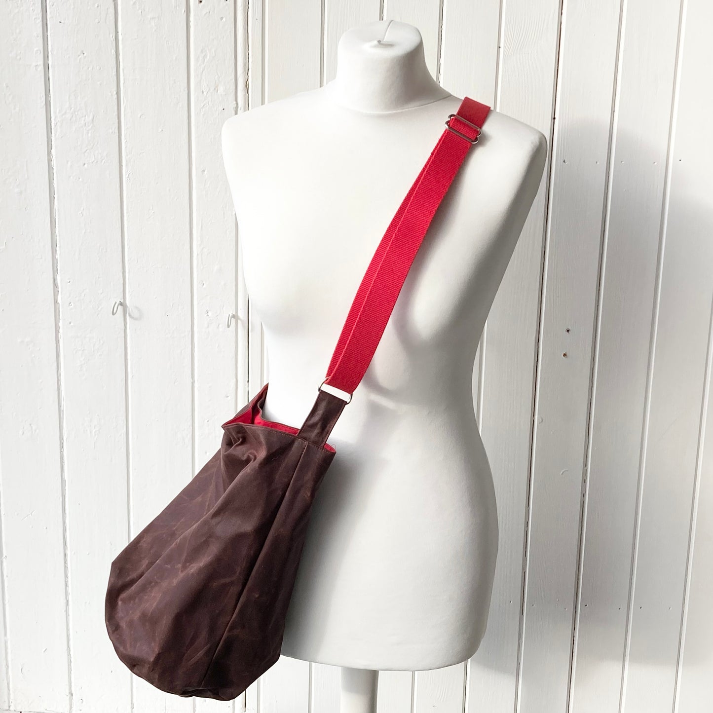 medium conker with red lining oilskin bucket bag