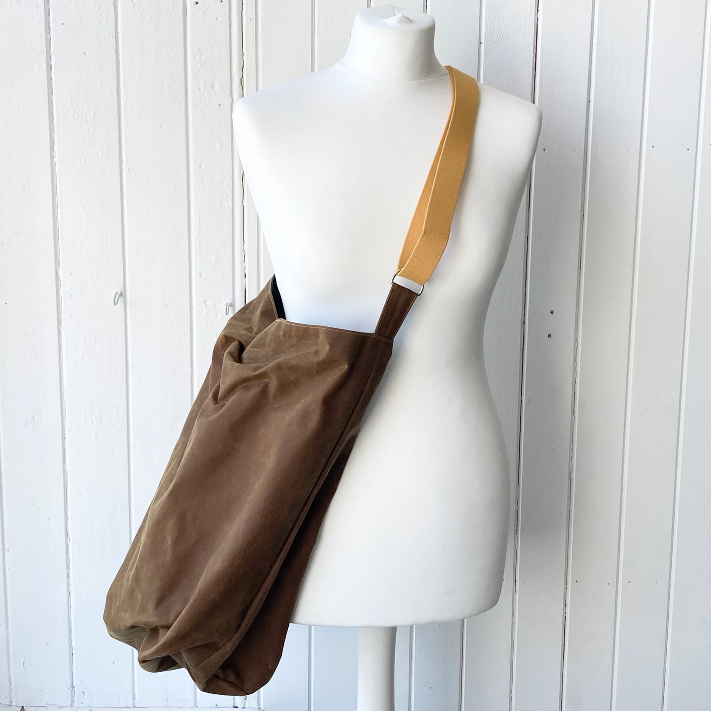 large tan oilskin bucket bag