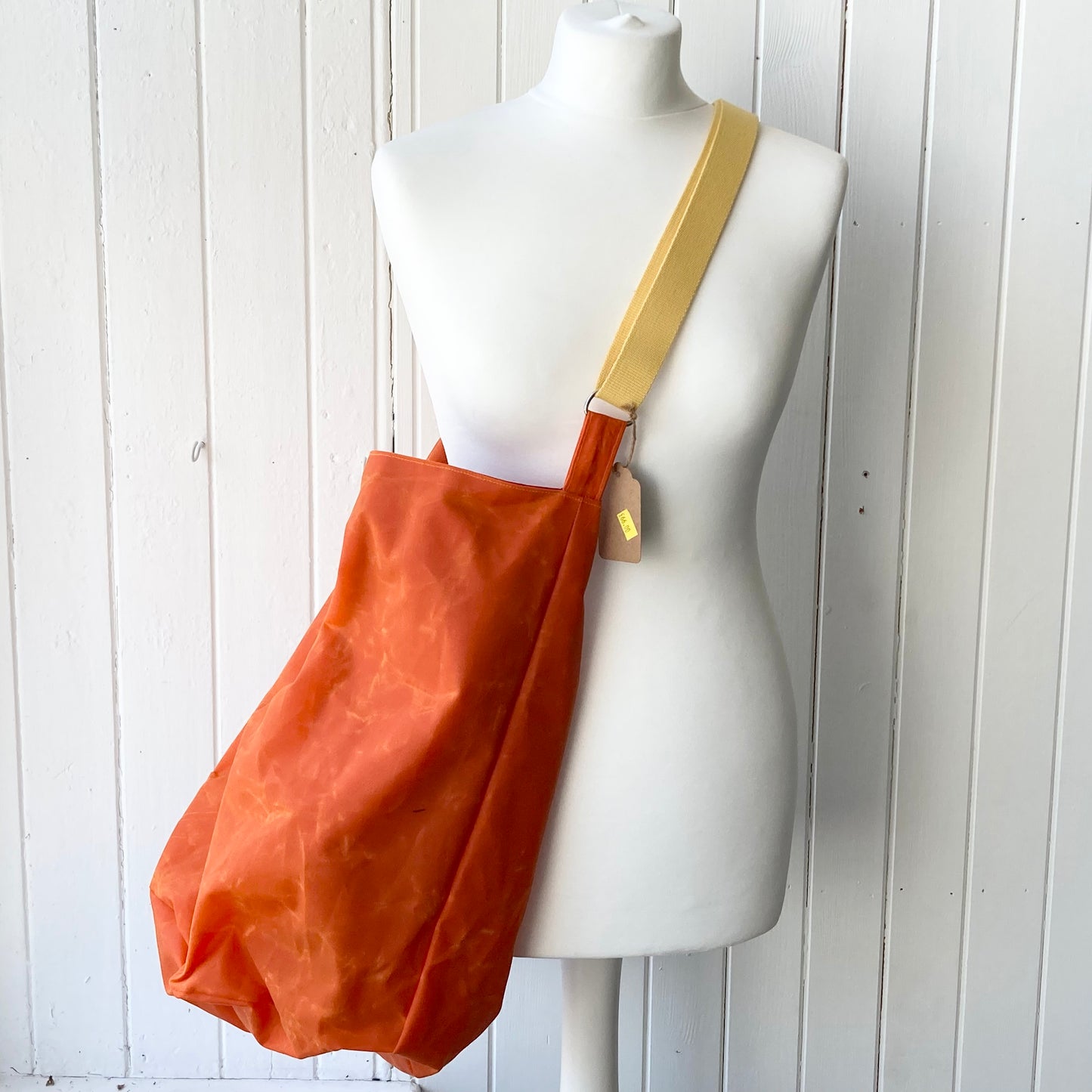 large orange with red lining oilskin bucket bag