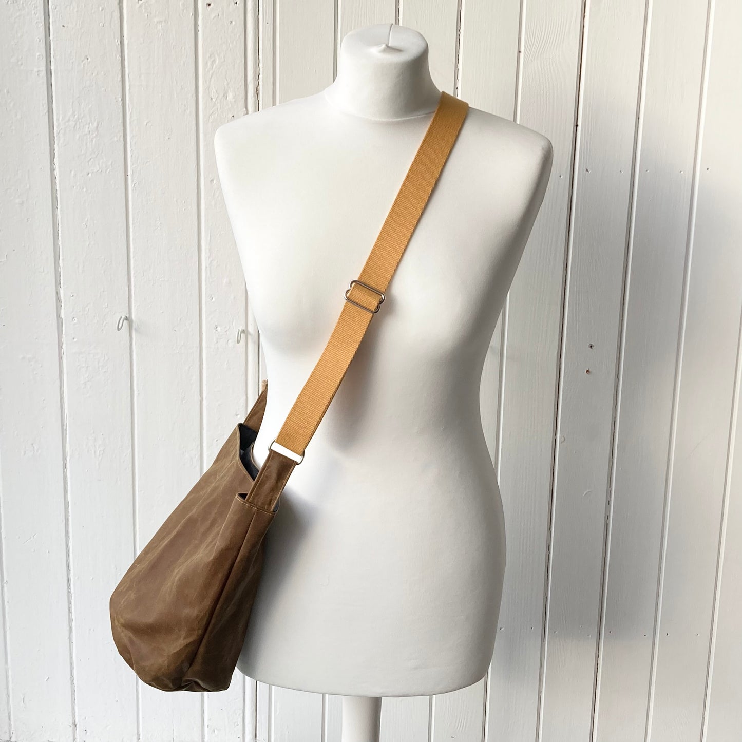 small tan oilskin bucket bag