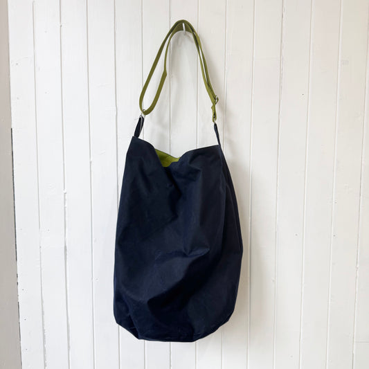 large dark blue oilskin bucket bag
