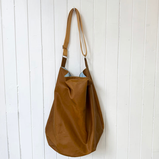 large tan oilskin bucket bag