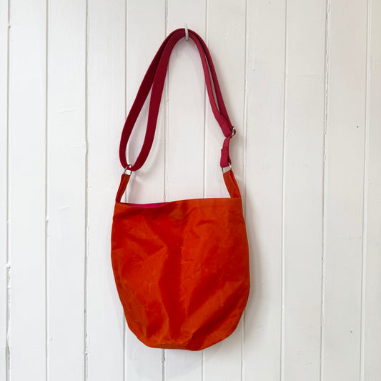 small orange oilskin bucket bag