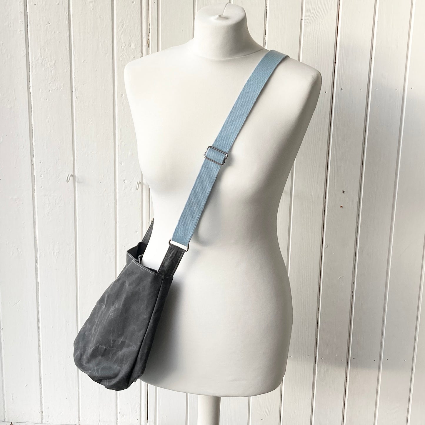 small grey with pale blue strap oilskin bucket bag