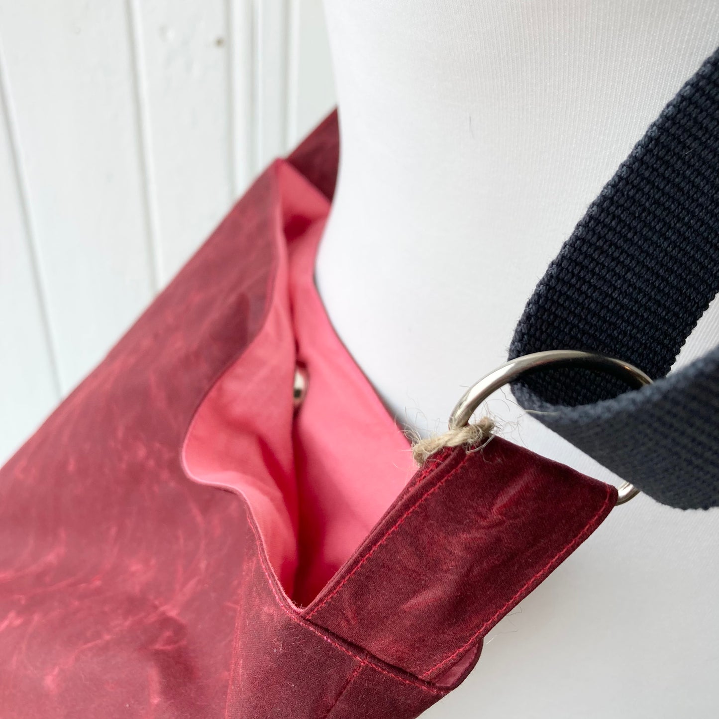 small dark red oilskin bucket bag with pale pink lining