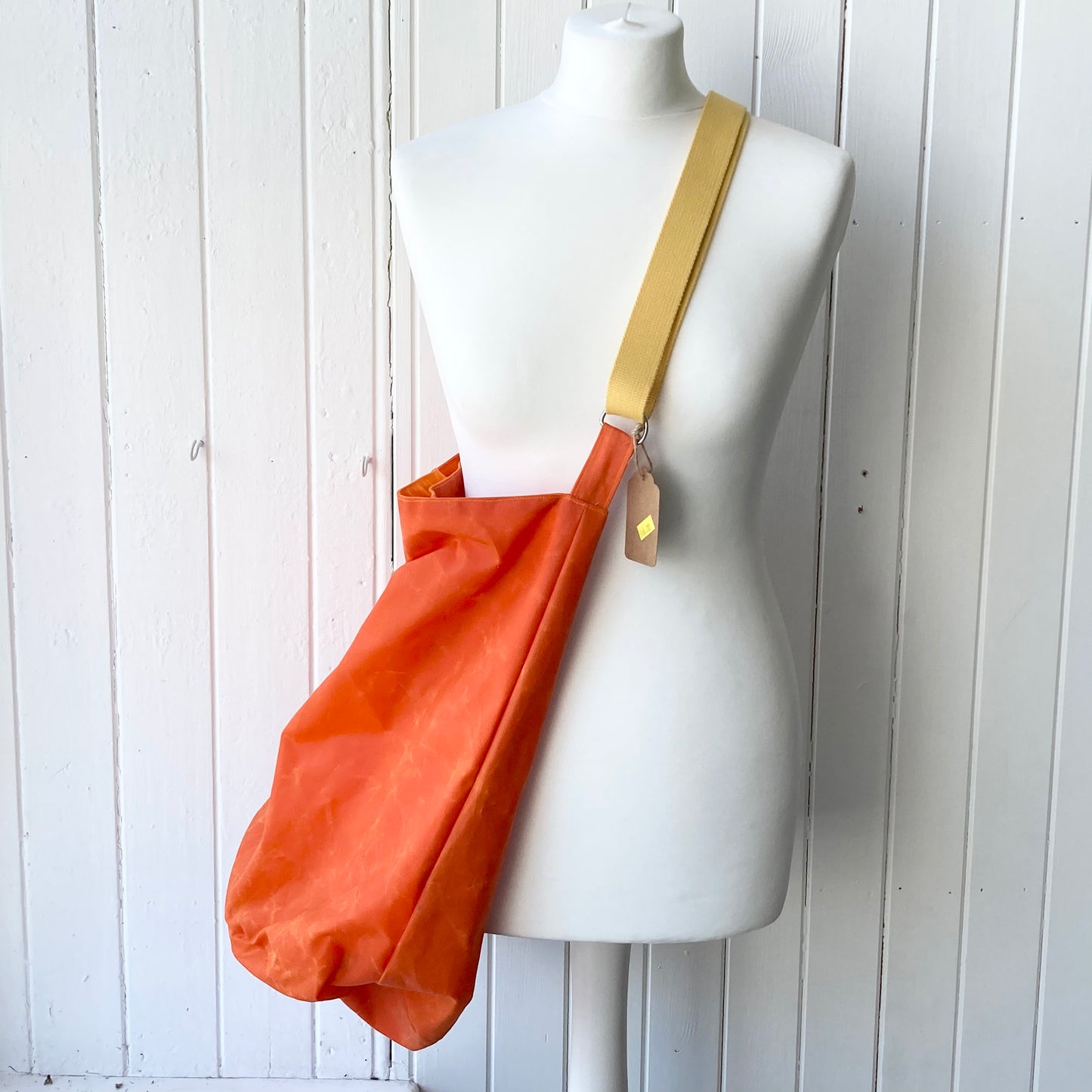 large orange with orange lining oilskin bucket bag